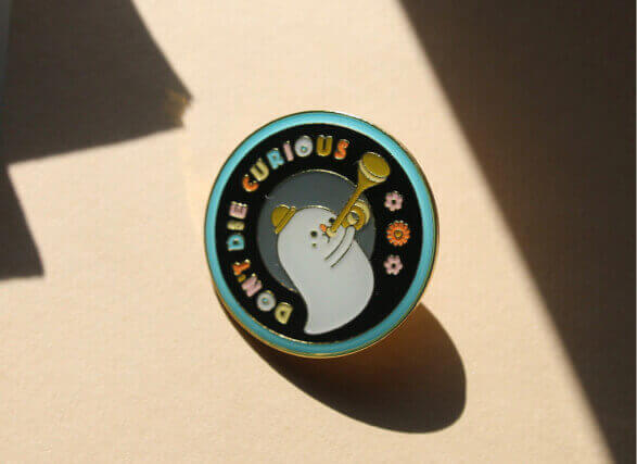 An enamel pin by Tom Rosenthal